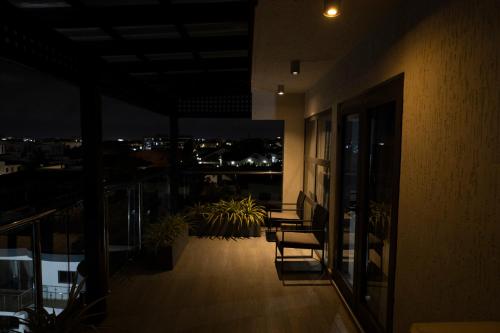 a balcony with a view of a city at night at Self made Estates in Accra