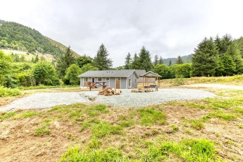 a cabin in the middle of a field with trees at Nehalem Coastal Oasis - Secluded Coastal Home with Hot Tub on 14 Acres in Nehalem
