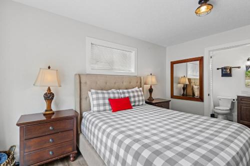 a bedroom with a bed with a red pillow on it at Nehalem Coastal Oasis - Secluded Coastal Home with Hot Tub on 14 Acres in Nehalem