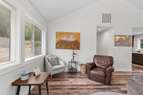 a living room with two chairs and a table at Nehalem Coastal Oasis - Secluded Coastal Home with Hot Tub on 14 Acres in Nehalem