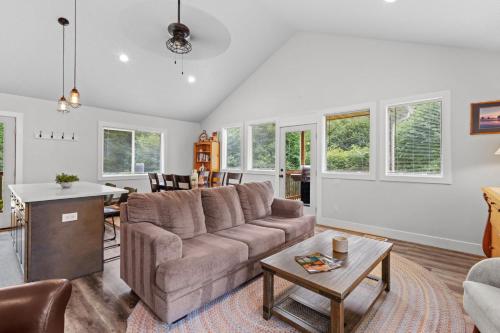 a living room with a couch and a table at Nehalem Coastal Oasis - Secluded Coastal Home with Hot Tub on 14 Acres in Nehalem