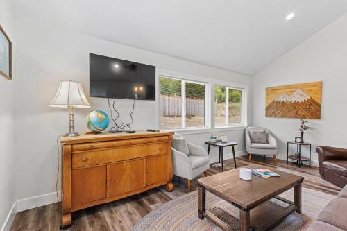 a living room with a couch and a tv at Nehalem Coastal Oasis - Secluded Coastal Home with Hot Tub on 14 Acres in Nehalem
