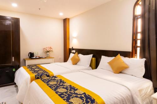 Ένα ή περισσότερα κρεβάτια σε δωμάτιο στο Atana Saigon Boutique Hotel II