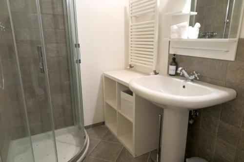 a bathroom with a sink and a shower at Residenza La Rocca 1227 - Borgo Castello di Serravalle in Castello di Serravalle