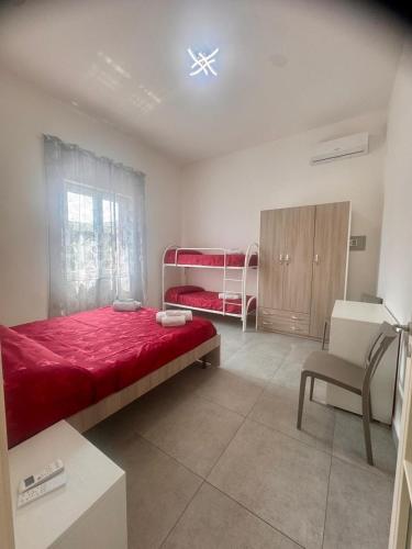 a bedroom with two bunk beds and a chair at Sarno La Vecchia Cascina in Sarno