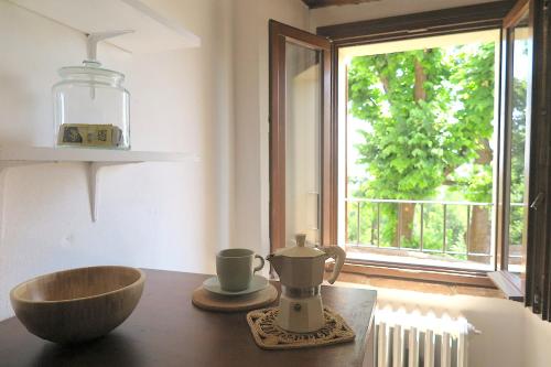 a kitchen with a table with a bowl and a window at Residenza La Rocca 1227 - Borgo Castello di Serravalle in Castello di Serravalle