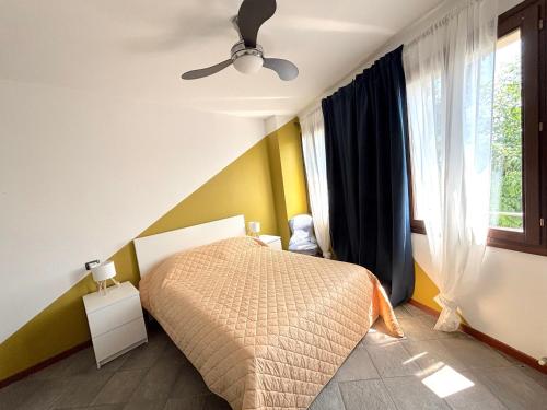 a bedroom with a bed and a window at Residenza La Rocca 1227 - Borgo Castello di Serravalle in Castello di Serravalle