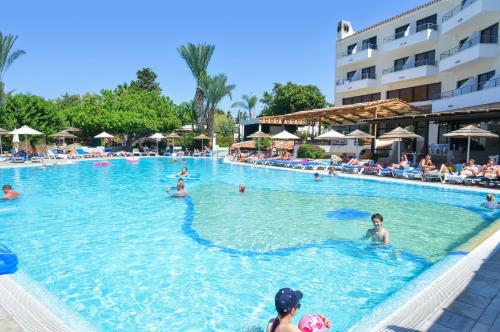 a group of people in the swimming pool at a resort at Paphos Gardens Holiday Resort in Paphos City