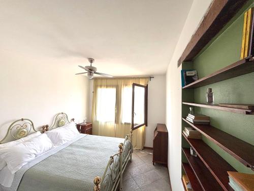a bedroom with a bed and a ceiling fan at Residenza La Rocca 1227 - Borgo Castello di Serravalle in Castello di Serravalle