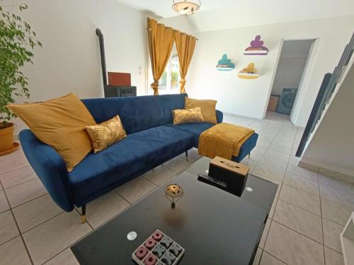 a blue couch sitting in a living room at La Maison du Sapin 