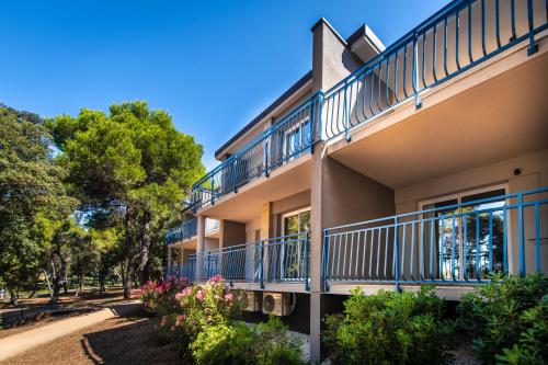 a building with balconies on the side of it at Arena Verudela Beach in Pula