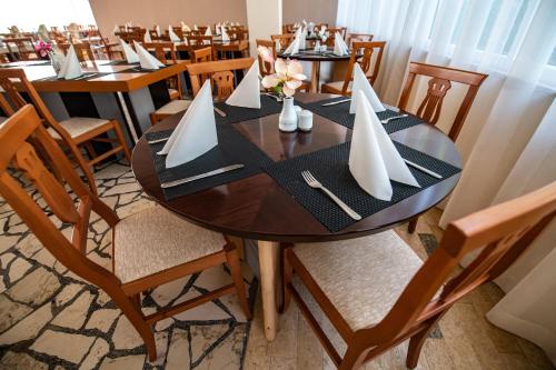 a wooden table with white paper boats on it at Horizont Resort in Pula