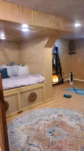 a bedroom with a bunk bed in a room with a rug at Downtown Boho Home wOffice Yoga StudioKing Bed in La Crosse