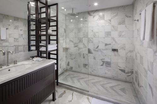 a bathroom with a tub and a sink and a shower at Verdi Tunis Beach Resort in Gammarth