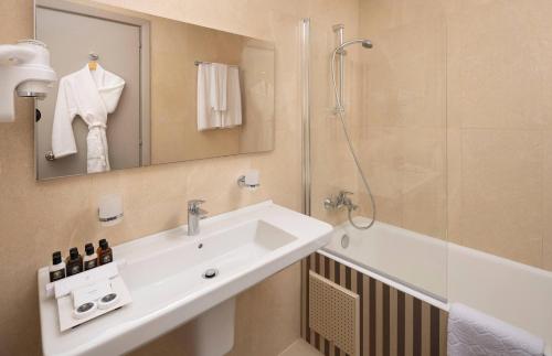 a bathroom with a sink and a shower at Verdi Tunis Beach Resort in Gammarth