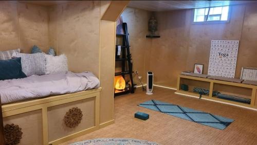 a room with a bed and a book shelf at Downtown Boho Home wOffice Yoga StudioKing Bed in La Crosse