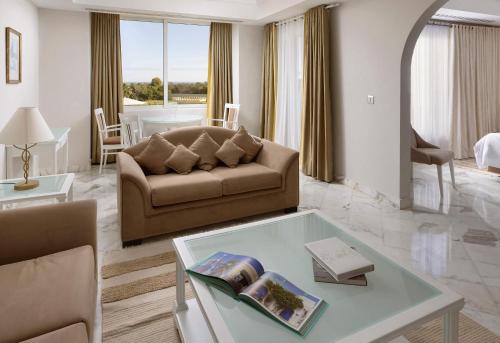 a living room with a couch and a table at Verdi Tunis Beach Resort in Gammarth