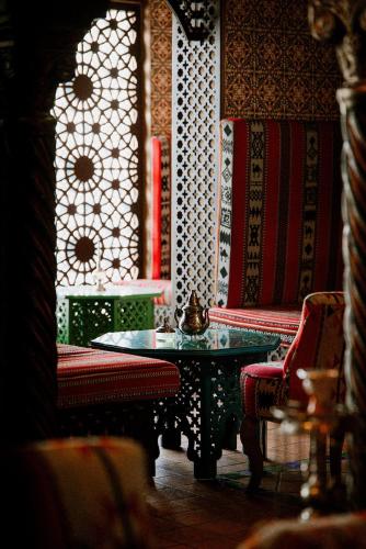 a room with a table and chairs and a window at Verdi Tunis Beach Resort in Gammarth
