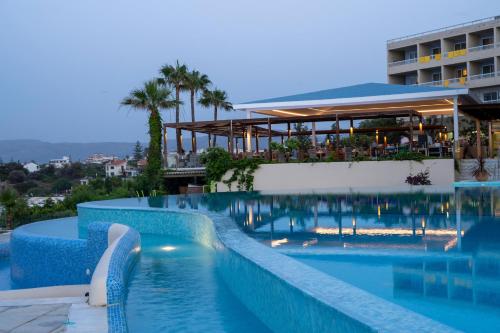 a large swimming pool in front of a building at Leptos Panorama Hotel in Kalamaki Chanion