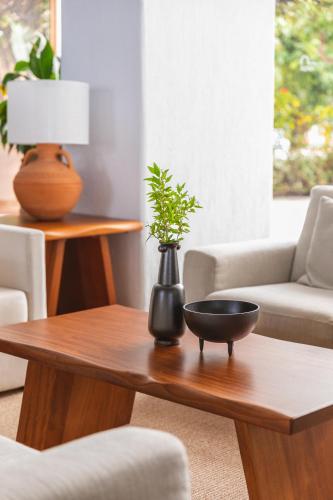 a living room with a table with a plant on it at Leptos Panorama Hotel in Kalamaki Chanion