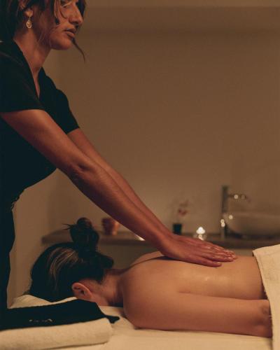 a woman is giving a woman a massage at Leptos Panorama Hotel in Kalamaki Chanion
