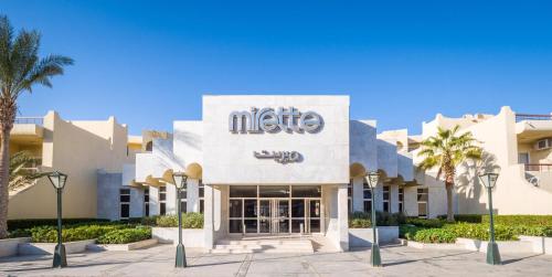 a hotel with a sign on the front of it at Sunny Days Mirette Family Resort in Hurghada