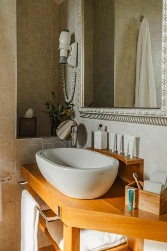a bathroom with a white sink and a mirror at Tenuta Borgo Santa Cecilia in Gubbio