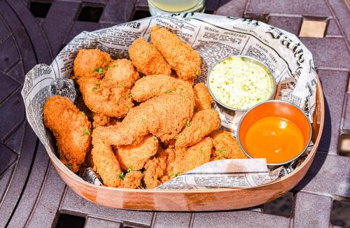 a bowl of fried food with dipping sauce on a table at Flying Horse Resort & Club in Colorado Springs