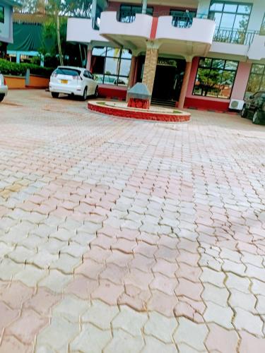 a brick driveway in front of a building at New Tourist Hotel in Mwanza