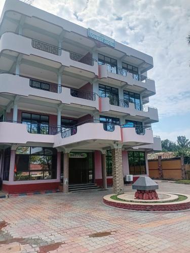 a building with a fountain in front of it at New Tourist Hotel in Mwanza