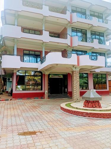 a large building with a courtyard in front of it at New Tourist Hotel in Mwanza