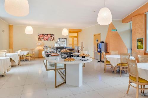 a restaurant with a table with food on it at B&B HOTEL Bergamo Executive in San Paolo D'Argon