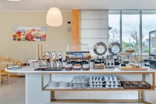 a kitchen with a counter with food on it at B&B HOTEL Bergamo Executive in San Paolo D'Argon