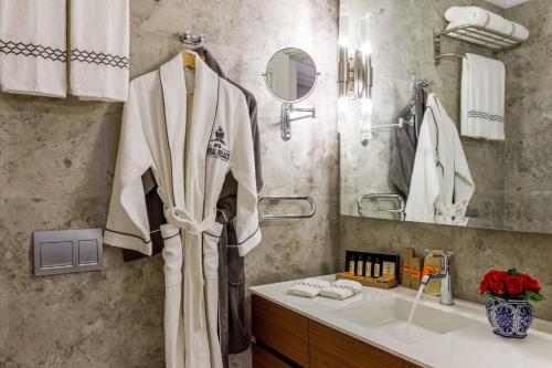 a bathroom with a robe hanging on the wall at Amiral Palace Hotel Boutique Class in Istanbul