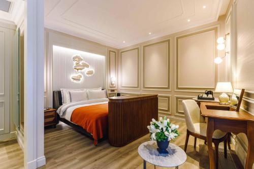 a hotel room with a bed and a desk and a desk at Amiral Palace Hotel Boutique Class in Istanbul