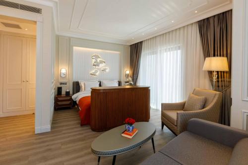 a hotel room with a bed and a couch at Amiral Palace Hotel Boutique Class in Istanbul