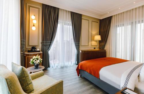 a hotel room with a bed and a couch at Amiral Palace Hotel Boutique Class in Istanbul