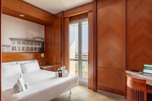 a bedroom with a bed and a large window at B&B Hotel Modena in Modena