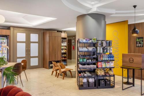 a store lobby with a shelf with products at B&B Hotel Modena in Modena