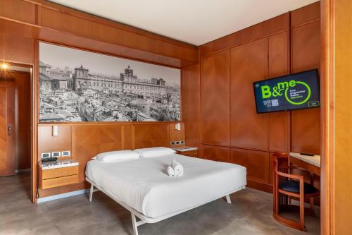 a bedroom with a bed and a tv on a wall at B&B Hotel Modena in Modena