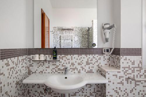 a bathroom with a sink and a mirror at B&B Hotel Modena in Modena
