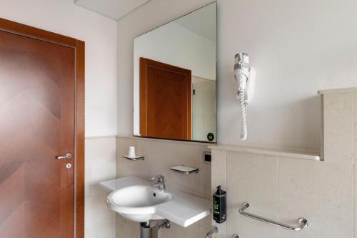 a bathroom with a sink and a mirror at B&B Hotel Modena in Modena