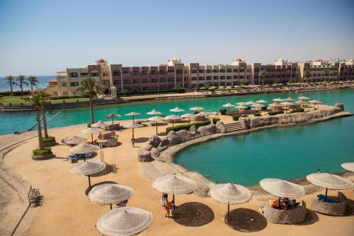 a group of umbrellas and chairs in a pool at Sunny Days El Palacio Resort & Spa in Hurghada