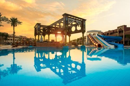 a swimming pool with a slide in a resort at Sunny Days El Palacio Resort & Spa in Hurghada
