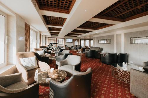 a waiting room with couches and tables in a hotel at Baron Hotel Cairo in Cairo