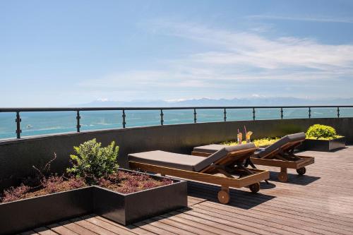 a deck with two lounge chairs and the ocean at Voyage Belek Golf & Spa Hotel in Belek
