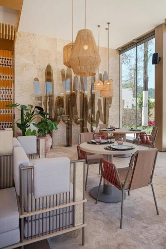 a dining room with a table and chairs at Voyage Torba Hotel in Torba