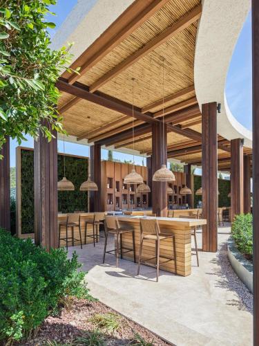 an outdoor patio with a table and chairs at Voyage Torba Hotel in Torba