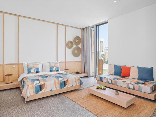 a bedroom with a bed and a couch at Voyage Torba Hotel in Torba