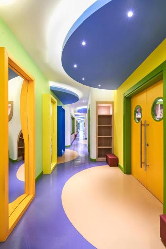 a hallway with colorful walls and a blue ceiling at Voyage Torba Hotel in Torba